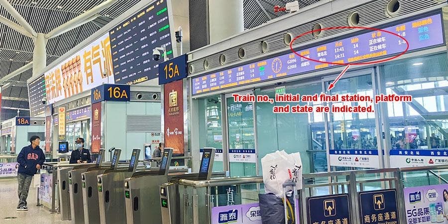 Railway boarding gates and a departure display, with an annotation explaining train numbers, stations and boarding status