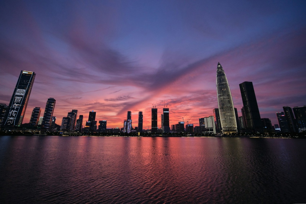 Shenzhen’s waterfront skyscrapers beneath a pink sunset